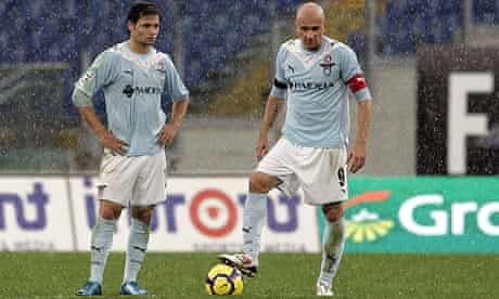 Dejected Lazio forwards Mauro Zarate and Tommaso Rocchi restart after Pato's goal