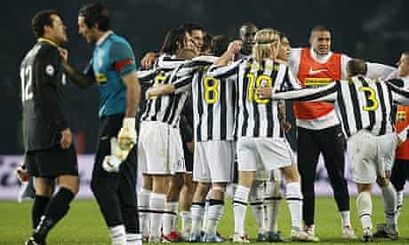 Juventus players celebrate as goalkeeper Gianluigi Buffon faces off with Inter's Julio Cesar
