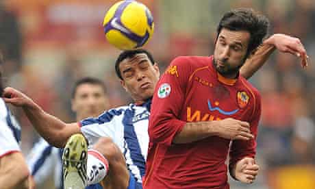 Mirko Vucinic, right, fights for the ball with Genoa defender Matteo Ferrari