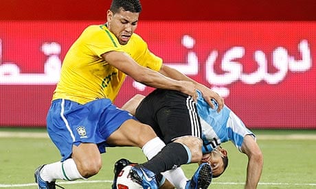 Brazil's Andre Dos Santos fights for the ball with Argentina's Javier Mascherano