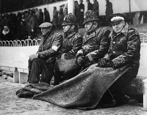 Football white-outs: Policemen and ambulancemen sitting on the touchline at White Hart Lane