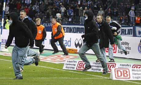 Hertha Berlin fans invade the pitch after their defeat to Nurnberg