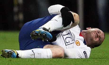 Manchester United's Wayne Rooney lies on the floor