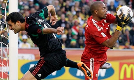 South Africa goalkeeper Moeneeb Josephs blocks a scoring chance for Mexico's Rafael Marquez
