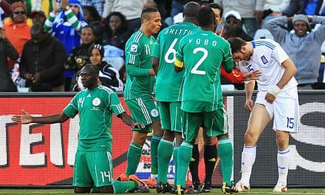 Vassilis Torosidis of Greece shows Nigeria players the mark on his leg after a tackle by Sani Kaita