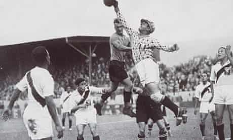 The Peruvian goalkeeper punches clear an Austrian attack during their match at the 1936 Games