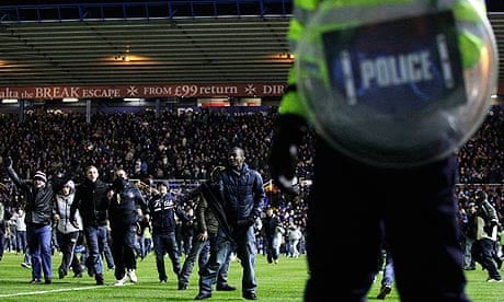 Birmingham City fans on the pitch after their Carling Cup win against Aston Villa