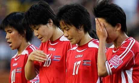 North Korean players leave the field after their 2-0 defeat to the USA