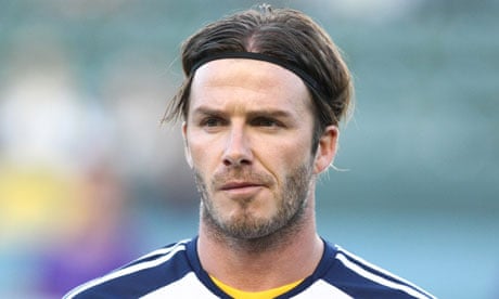 David Beckham sports longer hair as he arrives in Paris after a