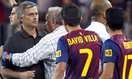 José Mourinho is restrained by a Barcelona offical during the aftermath of Marcelo's tackle
