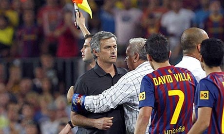 Real Madrid manager José Mourinho is restrained after Cesc Fábregas was fouled