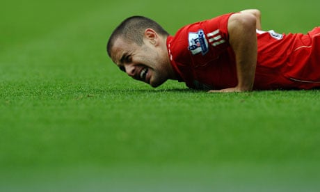 Liverpool's Joe Cole lies on the ground in pain