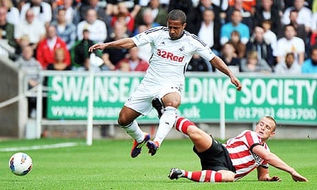 Swansea City's Wayne Routledge is caught by Sunderland's Lee Cattermole