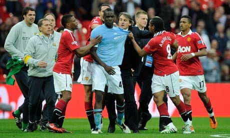Roberto Mancini drags Mario Balotelli out of trouble the last time both Manchester clubs met