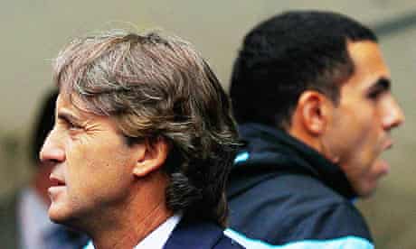 Manchester City's Roberto Mancini and Carlos Tevez