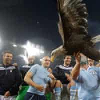 Lazio players celebrate with Olimpia the eagle