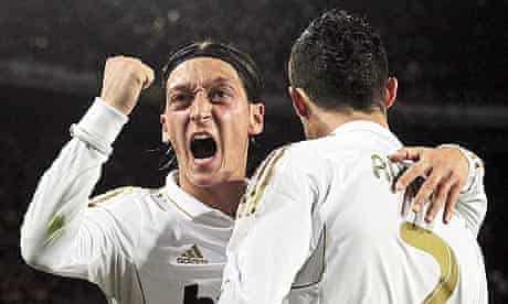 Real Madrid's Mesut Ozil, left, congratulates Cristiano Ronaldo on his winning goal at Barcelona