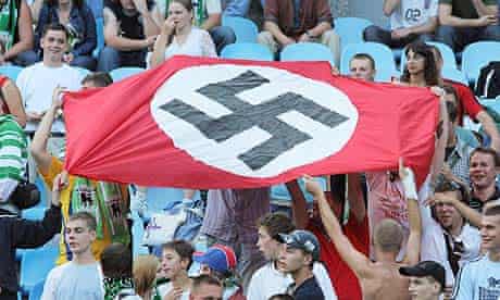 Supporters of Karpaty Lviv hold a Nazi flag with a swastika at a match against Dynamo Kyiv in 2007