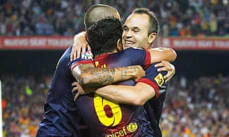 Barcelona's Xavi Hernandez, centre, celebrates with a group hug after scoring against Real Madrid 