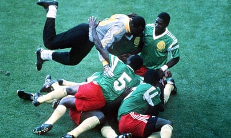 Cameroon players pile on top of each other as they celebrate the only goal
