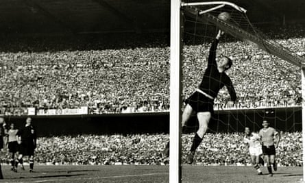 Uruguayan goalkeeper Roque Maspoli leaps to touch the ball over the bar.