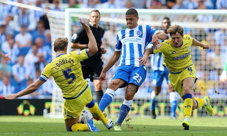 Brighton's Shamir Fenelon is tackled by Sheffield Wednesday's Glenn Loovens, left, at the Amex