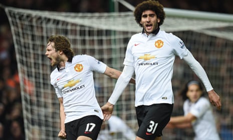 Manchester United's Daley Blind, left, and Marouane Fellaini celebrate their late equaliser