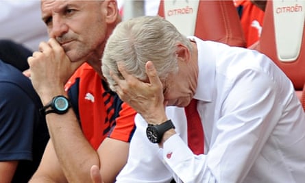 Arsenal's manager Arsène Wenger holds his head in exasperation during the defeat by West Ham.