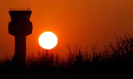 The sun sets behind the air traffic control tower at East Midlands Airport