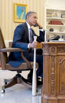 President Obama holds baseball bat while on phone to Turkish president
