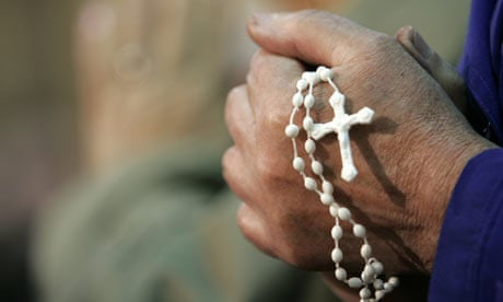 A rosary is held during prayer