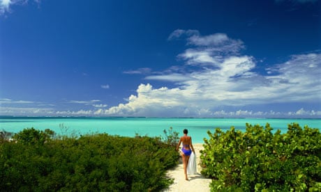Woman walking towards beach in Turks and Caicos Islands.