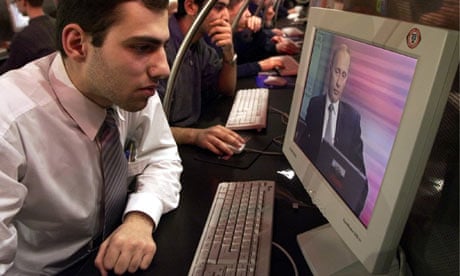 An Internet surfer watches an online interview of Vladimir Putin at an Internet cafe in Moscow