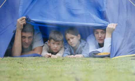 Family in a tent looking at the rain