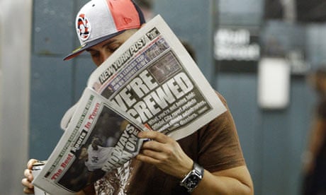 A man reads a fake edition of the New York Post