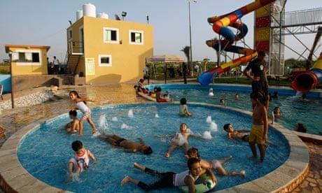 Palestinian children play in a pool at Crazy Water Park in August