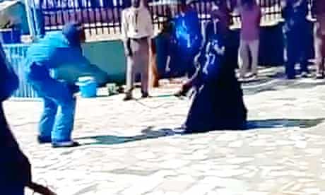 Screengrab from a YouTube clip of a woman being lashed in a carpark by police in Sudan.