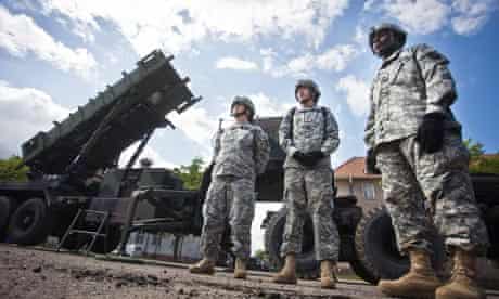US soldiers stand in front of a Patriot missile battery at an army base in the Polish town of Morag