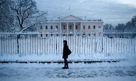 A woman walks on Pennsylvania Avenue in front of the White House after a snow storm
