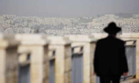 An ultra-Orthodox Jewish man walks in East Jerusalem, where Israel plans to build 1,600 homes.