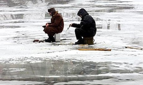 Two boys ice fishing on a frozen lake. Stock Illustration by