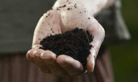 A hand holding some soil