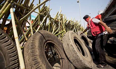 Red Shirt protesters build a barricade using bamboo poles and tyres at an intersection in Bangkok.