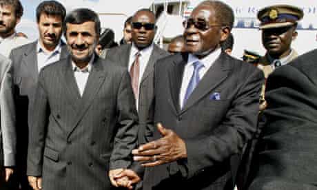 Robert Mugabe welcomes Mahmoud Ahmadinejad at Harare airport. 