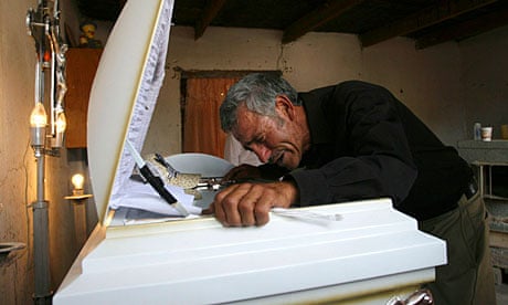Sergio's father, Jesus Librádo Hernández, mourns over the boy's coffin in Ciudad Juarez, Mexico.