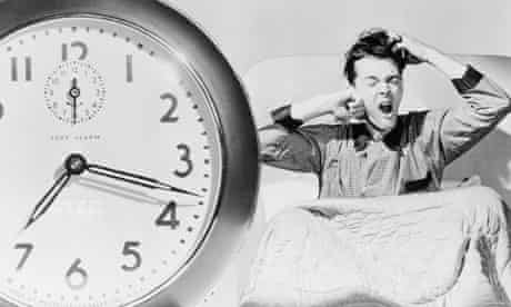 Man Waking Up To Alarm Clock