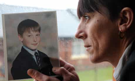 Adam Rickwood's mother holds a photo of him