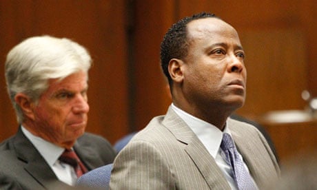 Dr Conrad Murray, right, listens to opening arguments with his attorney J Michael Flannigan