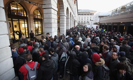 Customers queue outside the Apple store in Covent Garden to buy an iPhone 4S