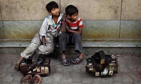 Shoeshine boys wait for customers in New Delhi, India
